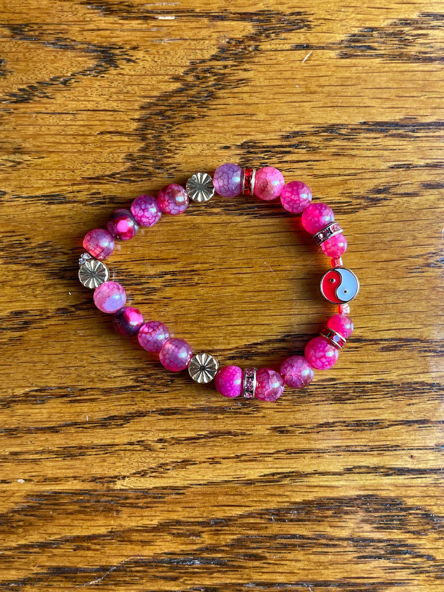 Pink crackle agate bracelet, with red yin & yang symbol