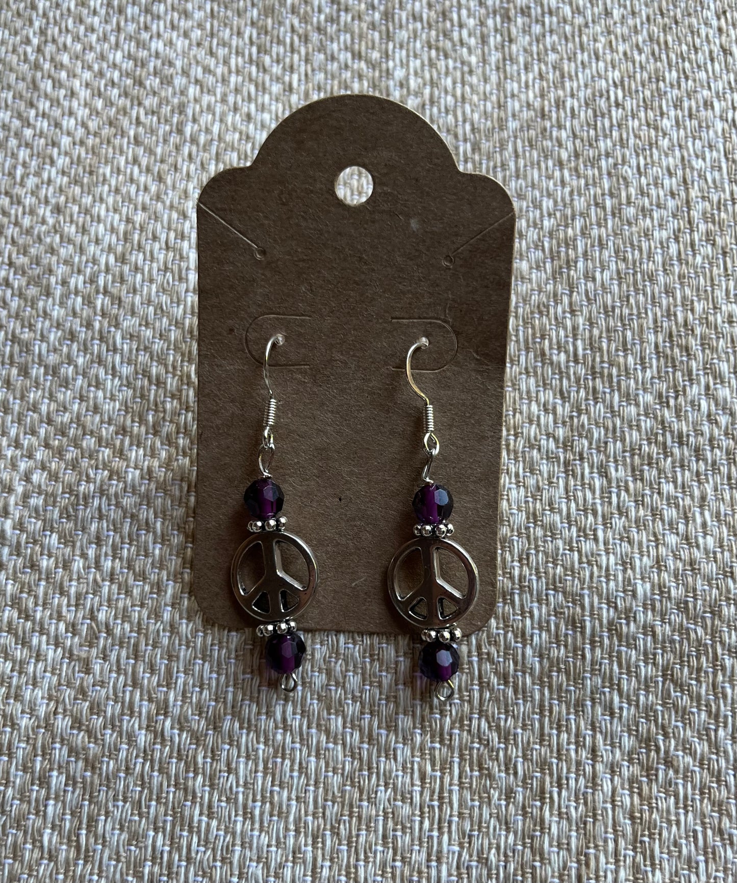 Peace sign earrings with purple glass beads